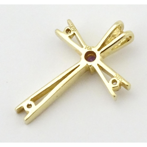 749 - A 14ct gold pendant of cross form set with amethysts and diamonds. Approx. 1