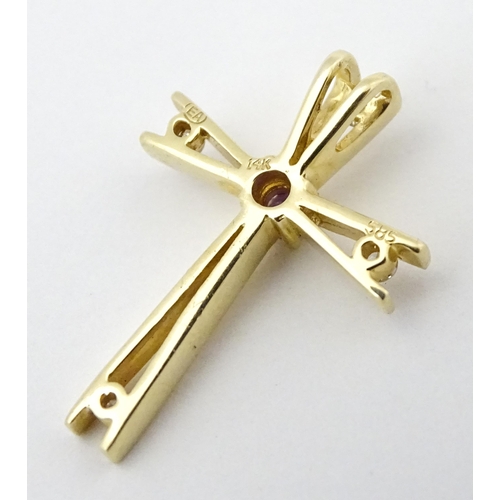 749 - A 14ct gold pendant of cross form set with amethysts and diamonds. Approx. 1