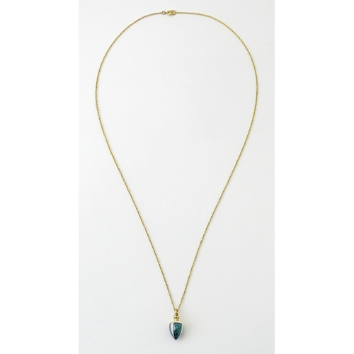 750 - A 9ct gold chain with a gilt metal pendant with enamel detail. Chain approx. 22