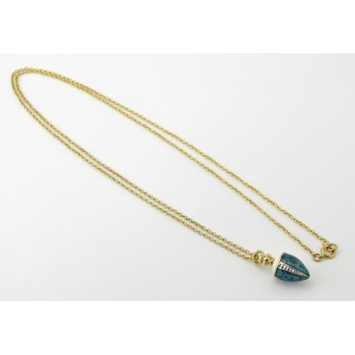 750 - A 9ct gold chain with a gilt metal pendant with enamel detail. Chain approx. 22