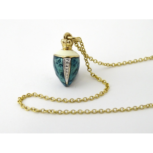 750 - A 9ct gold chain with a gilt metal pendant with enamel detail. Chain approx. 22