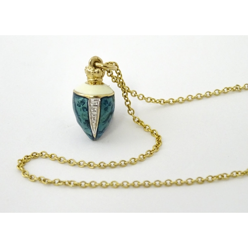 750 - A 9ct gold chain with a gilt metal pendant with enamel detail. Chain approx. 22