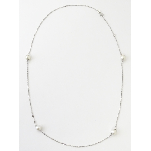 754 - An 18ct white gold necklace set with four pearls. Approx. 20