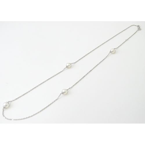 754 - An 18ct white gold necklace set with four pearls. Approx. 20