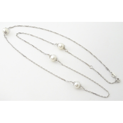 754 - An 18ct white gold necklace set with four pearls. Approx. 20