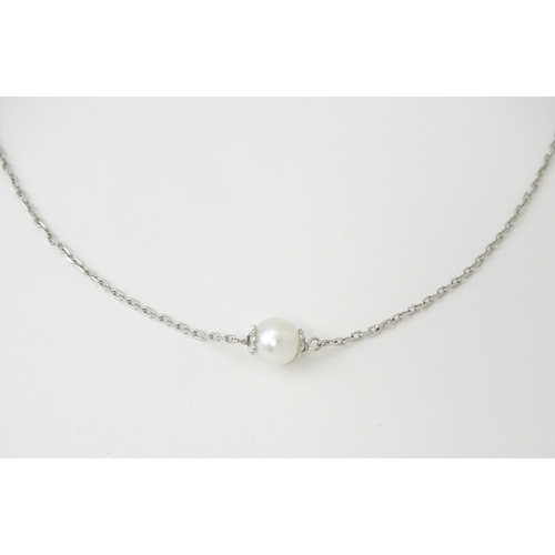 754 - An 18ct white gold necklace set with four pearls. Approx. 20