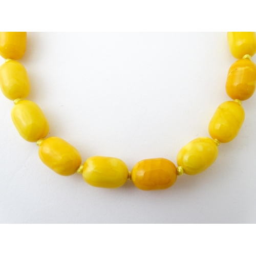 756 - A vintage butterscotch amber coloured bead necklace. Together with clip earrings. Necklace approx. 1... 