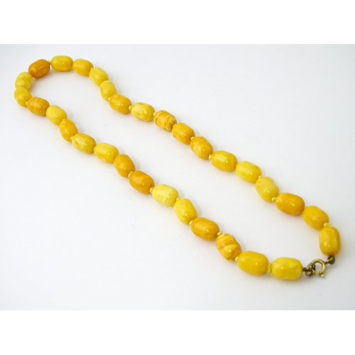 756 - A vintage butterscotch amber coloured bead necklace. Together with clip earrings. Necklace approx. 1... 