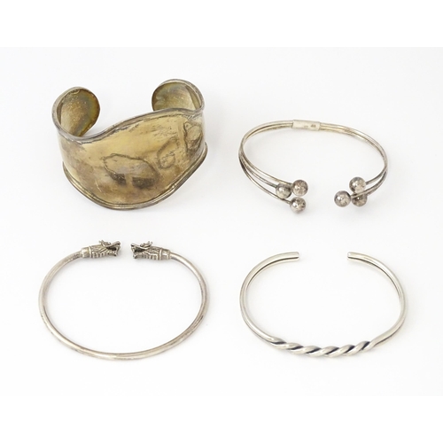 758 - Four silver / white bracelets of bangle form to include a Mexican example (4)