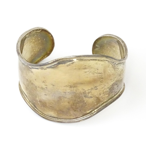 758 - Four silver / white bracelets of bangle form to include a Mexican example (4)