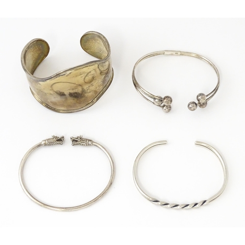 758 - Four silver / white bracelets of bangle form to include a Mexican example (4)