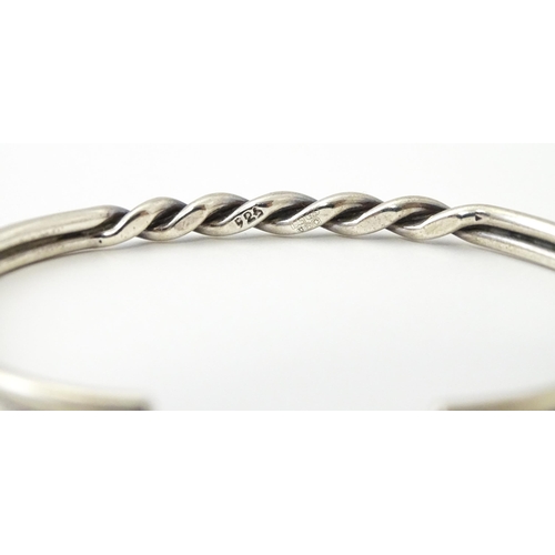 758 - Four silver / white bracelets of bangle form to include a Mexican example (4)