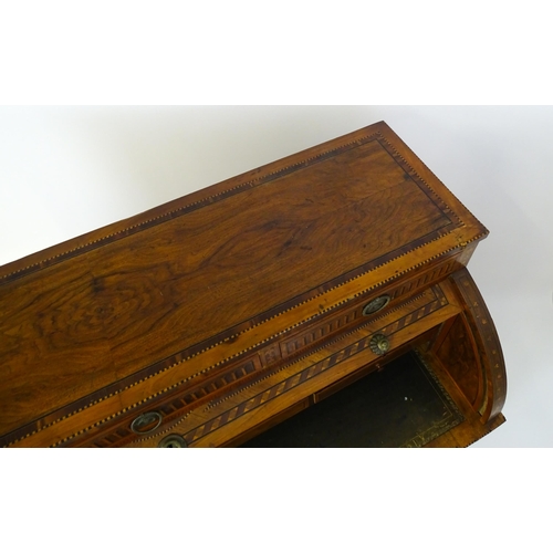 1454 - A 19thC continental desk with a roll top front having satinwood marquetry decoration alongside decor... 