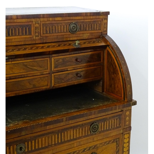 1454 - A 19thC continental desk with a roll top front having satinwood marquetry decoration alongside decor... 