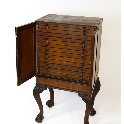 1495 - A 19thC mahogany Irish collectors cabinet with two panelled cupboard doors concealing twelve short d... 