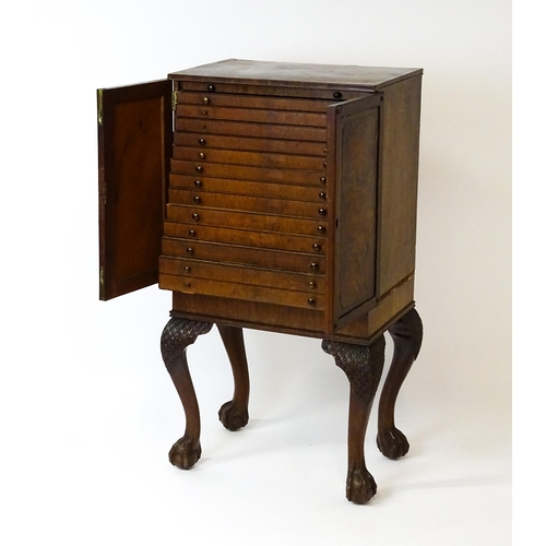 1495 - A 19thC mahogany Irish collectors cabinet with two panelled cupboard doors concealing twelve short d... 