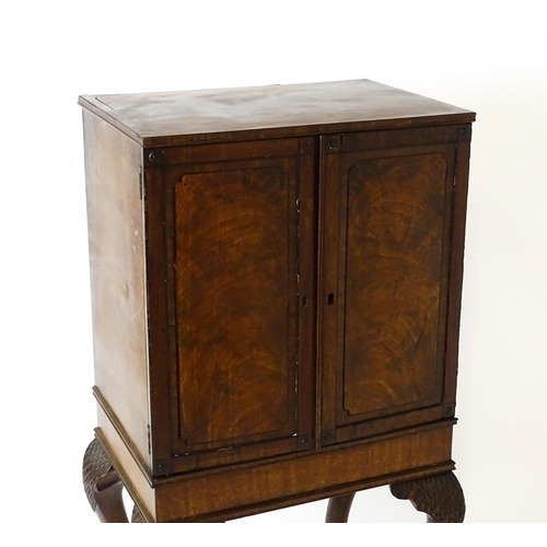 1495 - A 19thC mahogany Irish collectors cabinet with two panelled cupboard doors concealing twelve short d... 