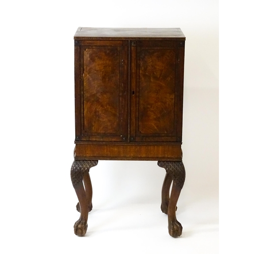 1495 - A 19thC mahogany Irish collectors cabinet with two panelled cupboard doors concealing twelve short d... 