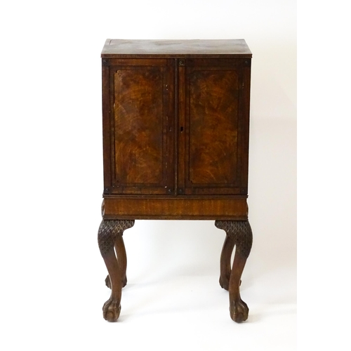 1495 - A 19thC mahogany Irish collectors cabinet with two panelled cupboard doors concealing twelve short d... 