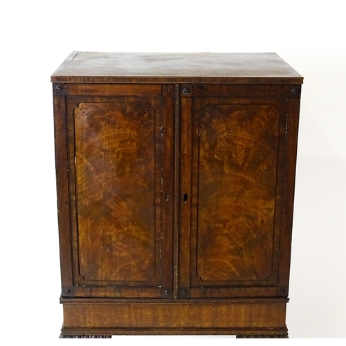 1495 - A 19thC mahogany Irish collectors cabinet with two panelled cupboard doors concealing twelve short d... 