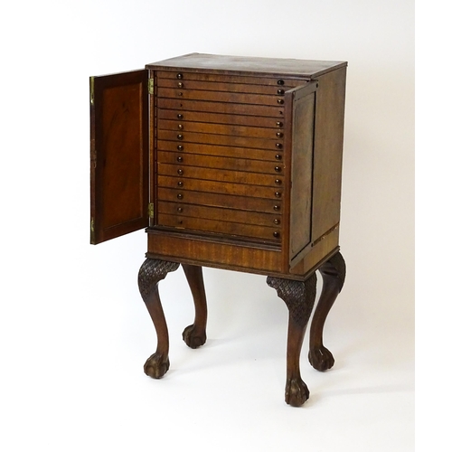 1495 - A 19thC mahogany Irish collectors cabinet with two panelled cupboard doors concealing twelve short d... 