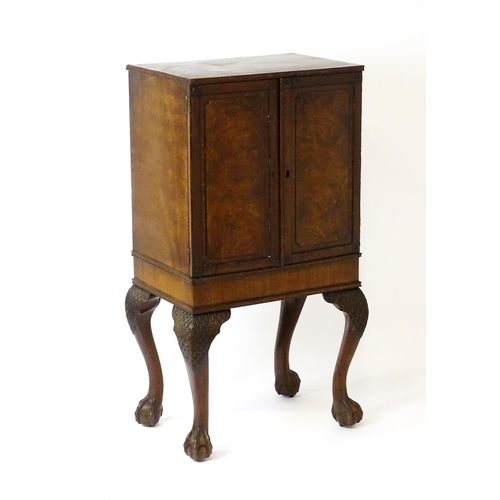 1495 - A 19thC mahogany Irish collectors cabinet with two panelled cupboard doors concealing twelve short d... 