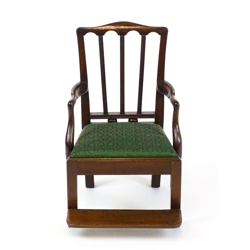 1500 - A late Georgian mahogany child's chair with swept arms and a foot rest. 17