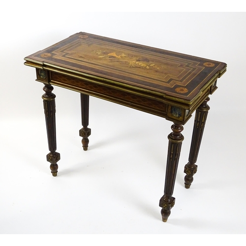 1513 - A 19thC card table with a marquetry inlaid cornucopia to the top and brass mouldings to the rim. The... 