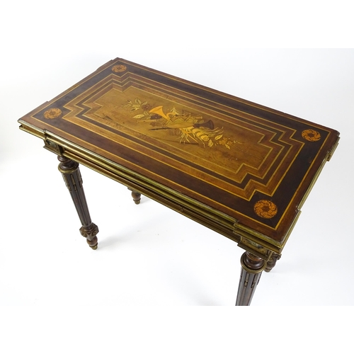 1513 - A 19thC card table with a marquetry inlaid cornucopia to the top and brass mouldings to the rim. The... 