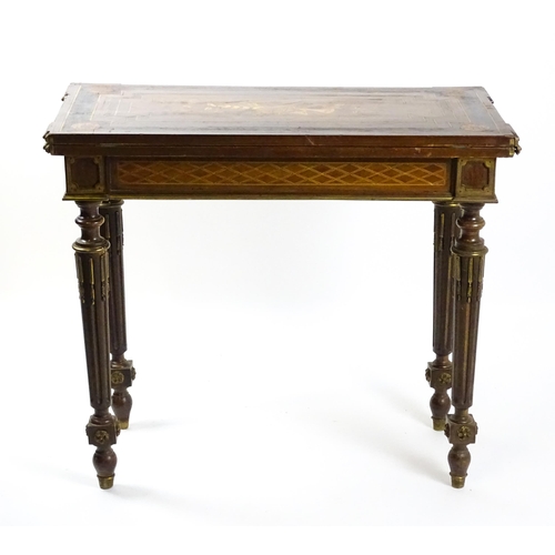 1513 - A 19thC card table with a marquetry inlaid cornucopia to the top and brass mouldings to the rim. The... 