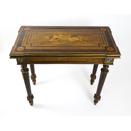 1513 - A 19thC card table with a marquetry inlaid cornucopia to the top and brass mouldings to the rim. The... 