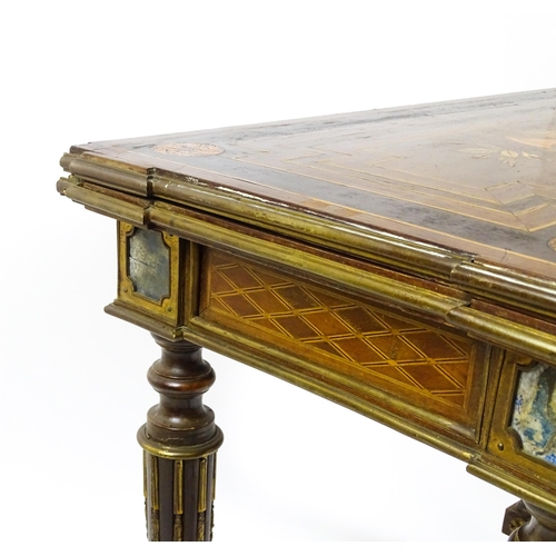 1513 - A 19thC card table with a marquetry inlaid cornucopia to the top and brass mouldings to the rim. The... 