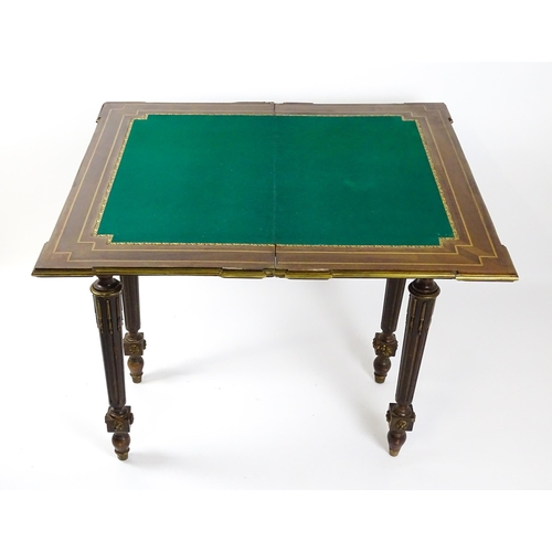 1513 - A 19thC card table with a marquetry inlaid cornucopia to the top and brass mouldings to the rim. The... 