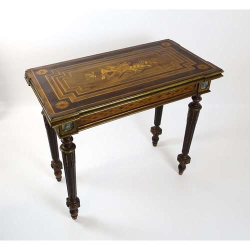 1513 - A 19thC card table with a marquetry inlaid cornucopia to the top and brass mouldings to the rim. The... 