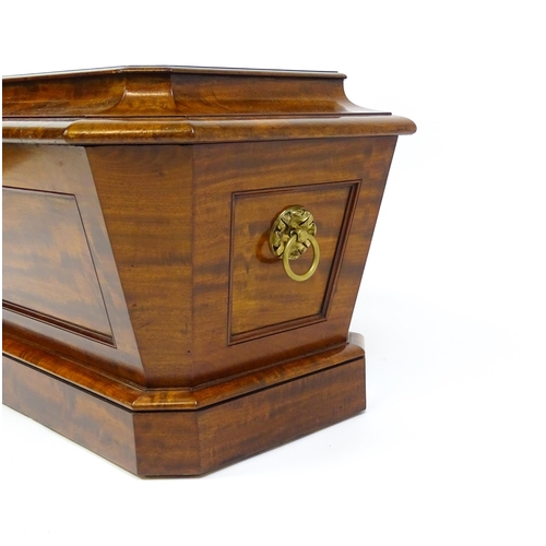 1533 - An early 19thC mahogany wine cooler of sarcophagus form with a moulded hinged lid above a panelled f... 