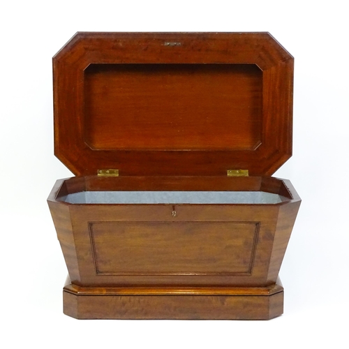 1533 - An early 19thC mahogany wine cooler of sarcophagus form with a moulded hinged lid above a panelled f... 