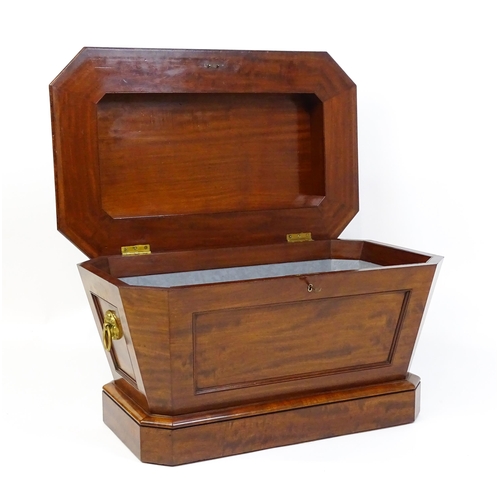 1533 - An early 19thC mahogany wine cooler of sarcophagus form with a moulded hinged lid above a panelled f... 