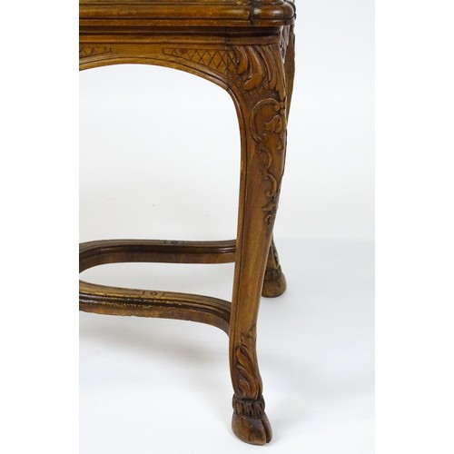 1541 - An early 20thC Louis XV style bergère stool with a caned top above four carved cabriole legs termina... 