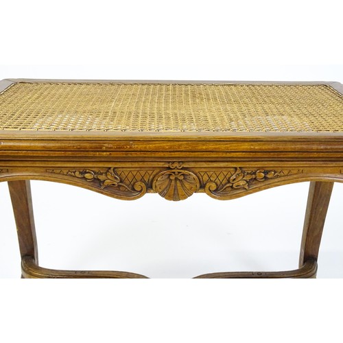 1541 - An early 20thC Louis XV style bergère stool with a caned top above four carved cabriole legs termina... 