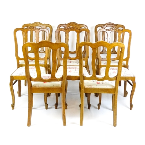 1578 - A set of eight oak French Louis XV style chairs with carved cresting rails, with drop in seats and r... 