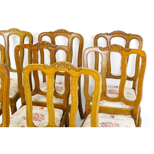 1578 - A set of eight oak French Louis XV style chairs with carved cresting rails, with drop in seats and r... 