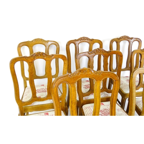 1578 - A set of eight oak French Louis XV style chairs with carved cresting rails, with drop in seats and r... 