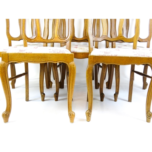 1578 - A set of eight oak French Louis XV style chairs with carved cresting rails, with drop in seats and r... 