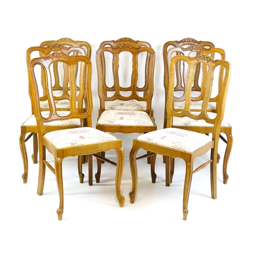 1578 - A set of eight oak French Louis XV style chairs with carved cresting rails, with drop in seats and r... 