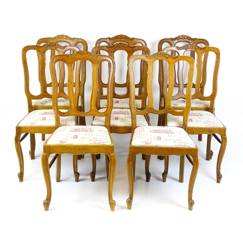 1578 - A set of eight oak French Louis XV style chairs with carved cresting rails, with drop in seats and r... 