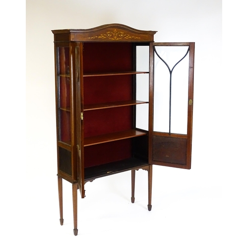 1588 - An Edwardian mahogany display cabinet with a shaped pediment, satinwood inlaid frieze and having two... 