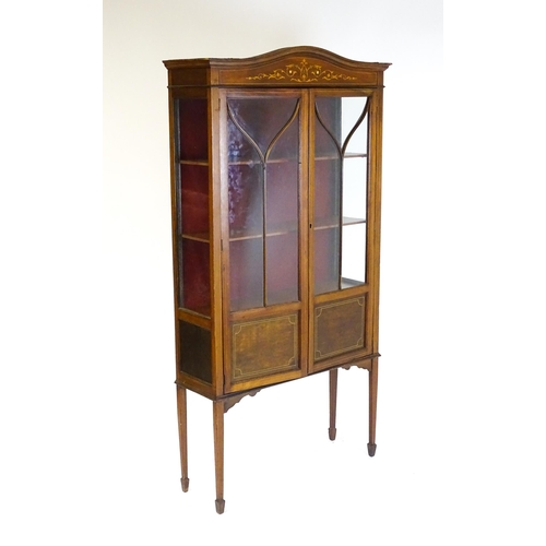 1588 - An Edwardian mahogany display cabinet with a shaped pediment, satinwood inlaid frieze and having two... 