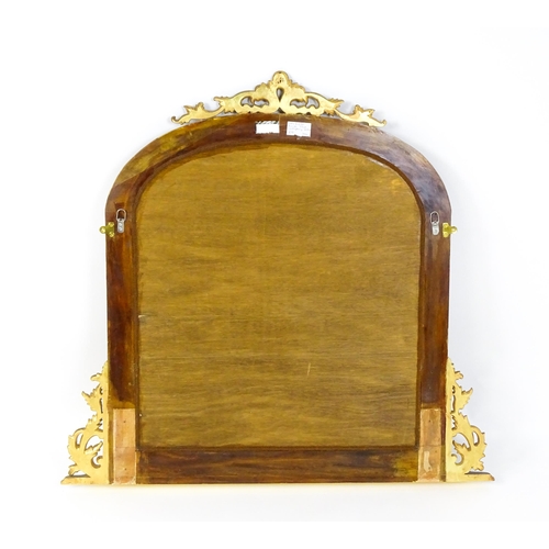 1598 - A modern mahogany mirror with a gilt finish, surmounted by a pierced, floral moulding and having mat... 