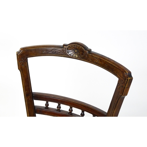 1599 - An Edwardian adjustable piano stool / chair with a floral carved top rail and turned finials to the ... 