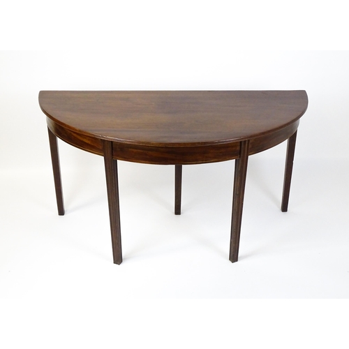 1600 - A 19thC mahogany D - End table raised on five chamfered, tapering legs. 52